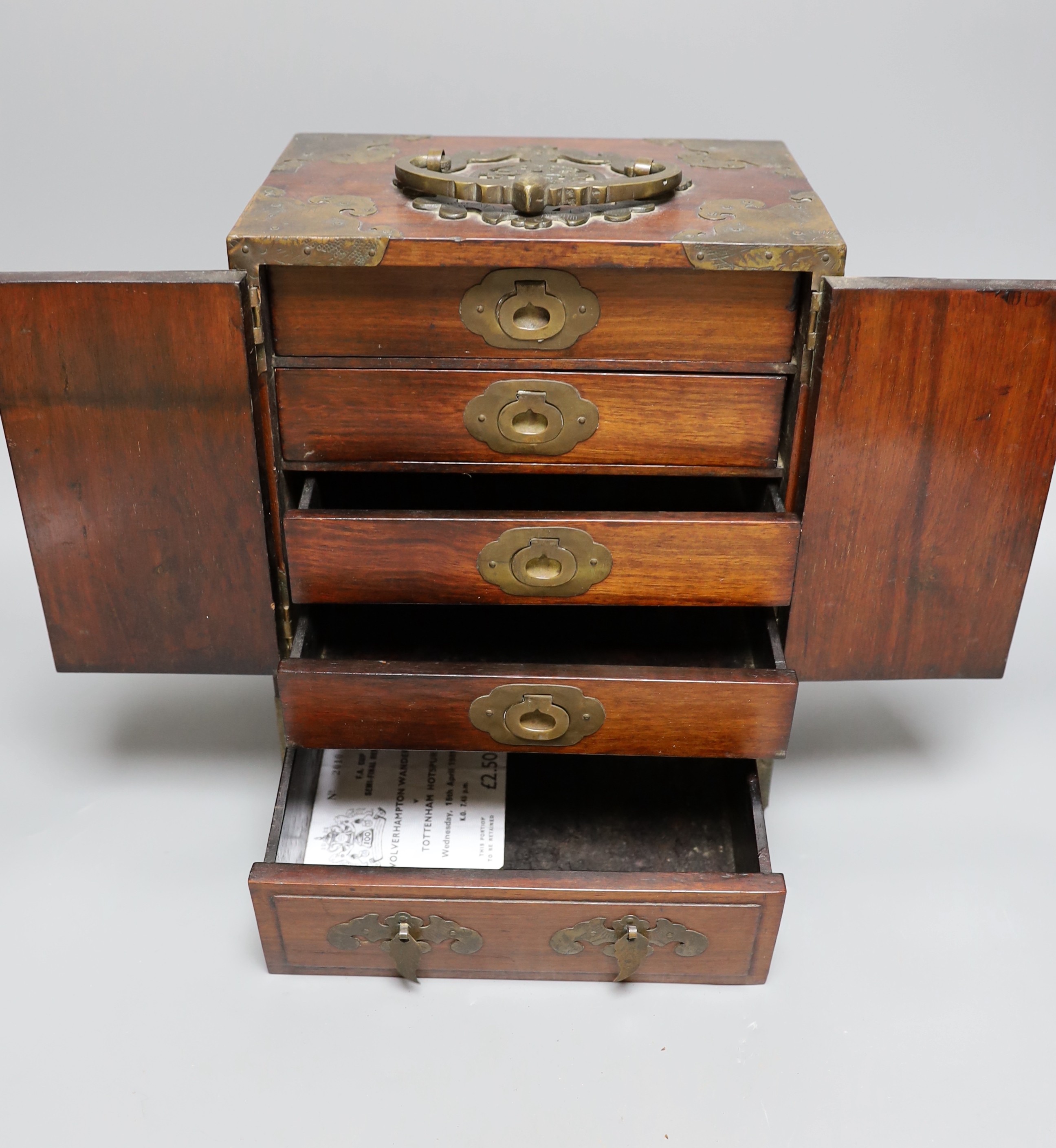A Chinese brass mounted two door, five drawer cabinet, 29 cms high